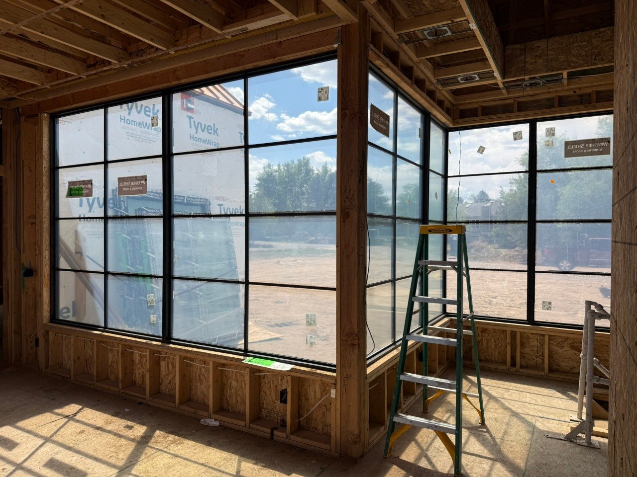 Black grid windows installed in new construction interior